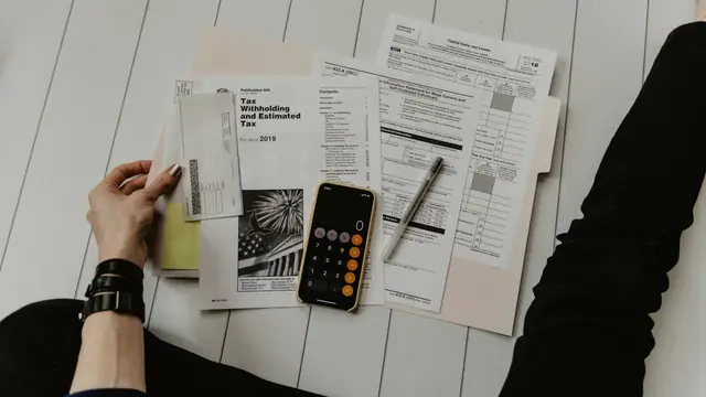 Documents and a calculator on a desk