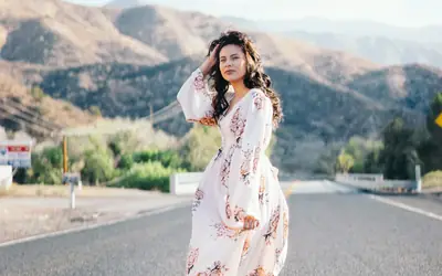 Woman posing for a portrait on a hill road