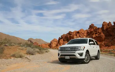 White SUV on a desert road