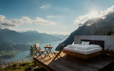 Bed on a terrace overlooking mountains